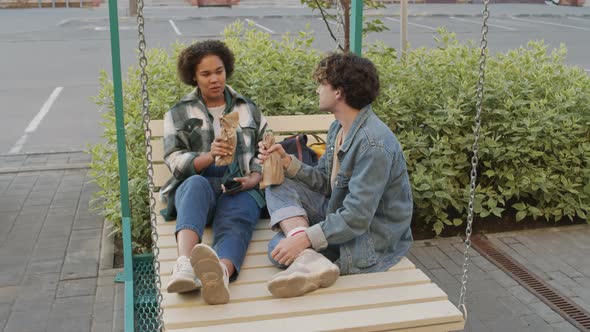 Students Drinking from Bottles in Paper Bags alt