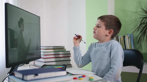 Video Broadcast of Lesson, Boy Schoolboy Teaches Mathematics By Video Link with Teacher Using Modern