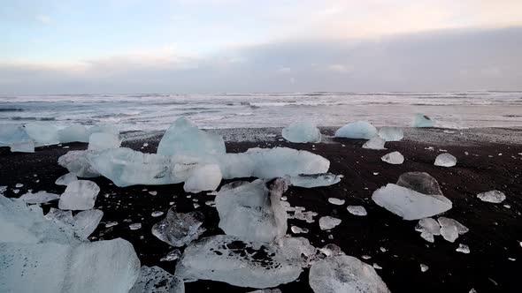 Icelandic Video 5Diamond beach, Iceland. Icebergs on the ocean. Blue ice against black sand. alt