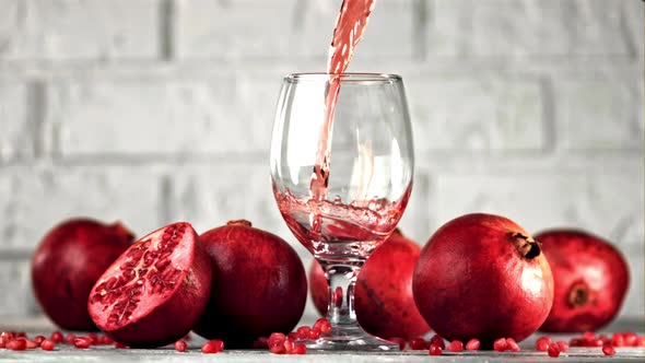 Super Slow Motion of the Rocket of Pomegranate Juice Pours Into the Glass alt