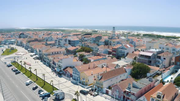 Drone shot of Costa Nova Do Prado in Portugal, street with colorful and striped houses 4K