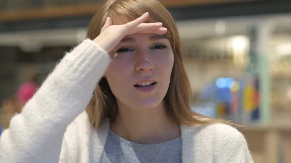 Searching Gesture by Young Woman Sitting in Cafe alt