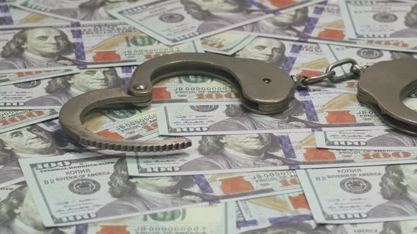 One Hundred Dollar Bills And Handcuffs