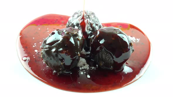 Fruit sauce poured into chocolate balls