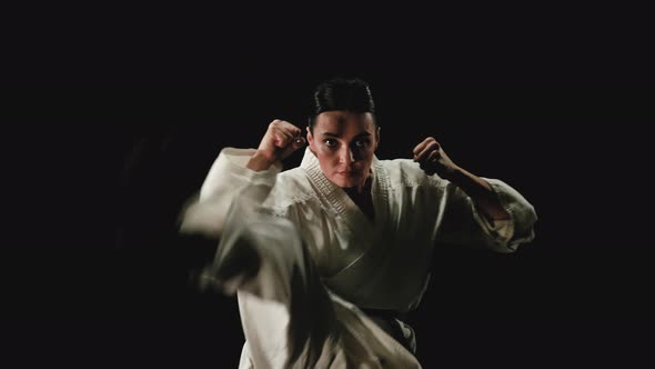 Young Woman in Kimono Practicing Karate alt