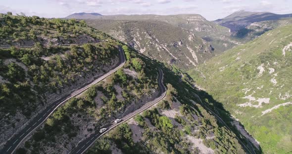 Aerial Drone View of Cars Passing Through Curve Roads on Serpentines in France alt