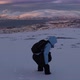 Girl playing in the snow on Storsteinen mount, Tromso in the background, Norway - VideoHive Item for Sale