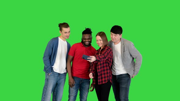 Multiracial Group of Young Friends Make Selfie and Laugh on a Green Screen Chroma Key