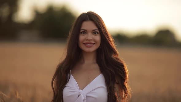 Beautiful Woman Smiling at Camera Outdoors.