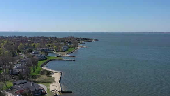 A high angle drone view over Bay Shore, NY, on a sunny day with clear skies. The camera dolly in ove alt