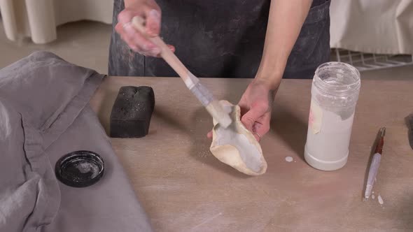 Potter Apply Glaze On Clay alt