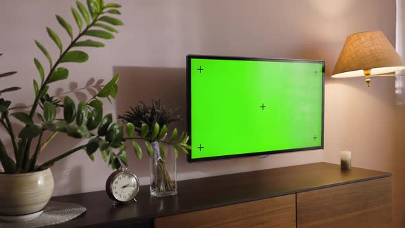 Stylish Apartment Interior with TV Set with Green Screen Mock Up Display Hangs Under Modern Commode