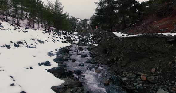 Drone shots of stream and small waterfalls created by melting snow in Troodos Mountain Cyprus. alt