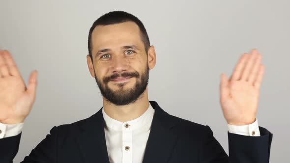Young Handsome Businessman in Blue Suit Says Goodbye To the Client and Waves His Hand alt