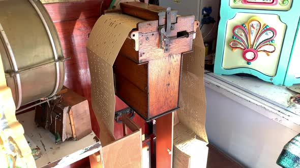 Music roll playing from an old musical instrument. Handheld alt