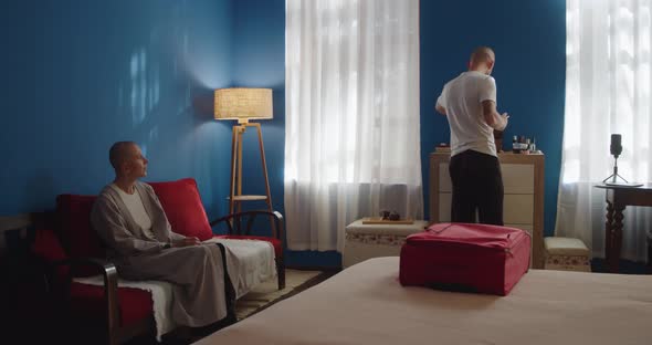 Young Couple Packing Things for Trip Together alt