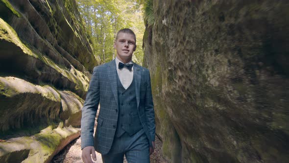 Legs of a Man Walking in the Park or in the Woods in Sacks and Pants alt