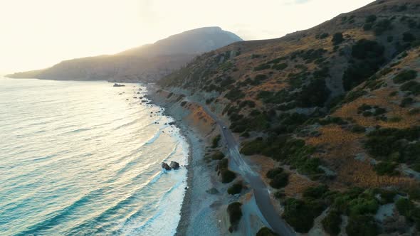 Car Driving on Road at Sea or Ocean Shore at Sunset. Aerial GreekLandscape