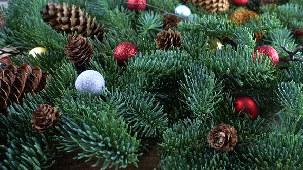 Abies nobilis branch with cones and Christmas balls alt