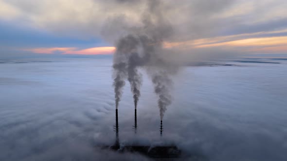 Coal Power Plant High Pipes with Black Smoke Moving Upwards Polluting Atmosphere alt