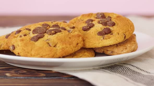 Pile of Chocolate Chip Cookies on White Plate on Wooden Table