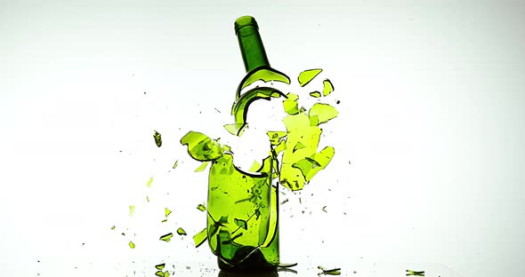Bottle of White Wine Breaking and Splashing against White Background, Slow motion 4K