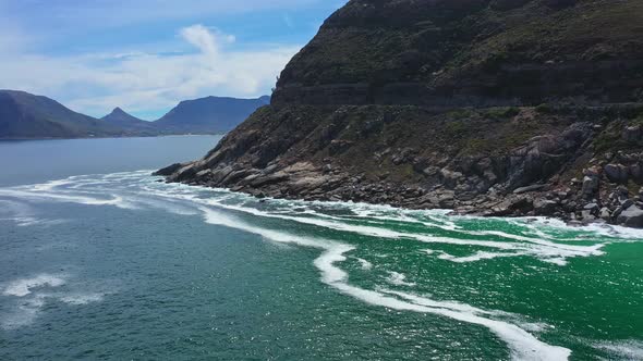 Stunning Aerial Footage of Rocky Coast and Turquoise Sea Waves Along Chapmans Peak Drive Road