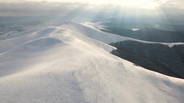 Amazing Aerial Flight Over Misty Mountain Range Meadows and Snow Covered Peaks in Winter Time alt