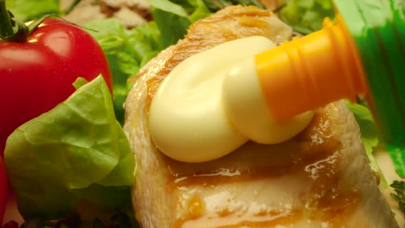 Close Up Delicious Grilled Chicken Is Covering with Mayonnaise with Fresh Greens and Spice