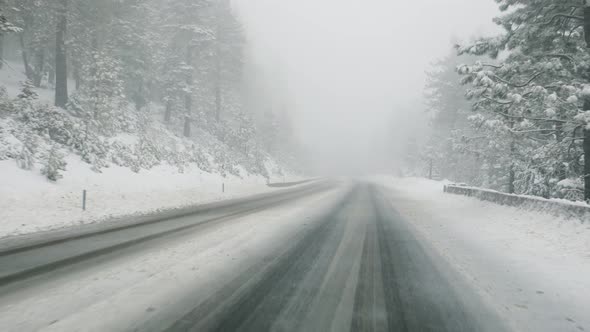 Driving on mountain road in snowstorm
