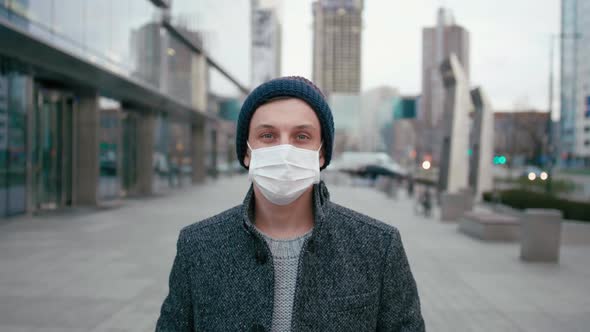 SARS-CoV-2 COVID-19 Coronavirus Pandemic: Man in Surgical Face Mask in Street
