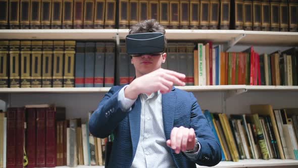 Slow motion, young man sitting indoor using 3D viewer alt