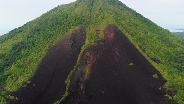 Aerial: flying over Banda Islands active volcano Gunung Api lava flows Indonesia alt