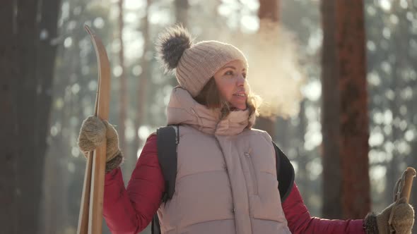 Young Woman Skier Enjoying Nature in Winter Frosty Sunny Weather alt