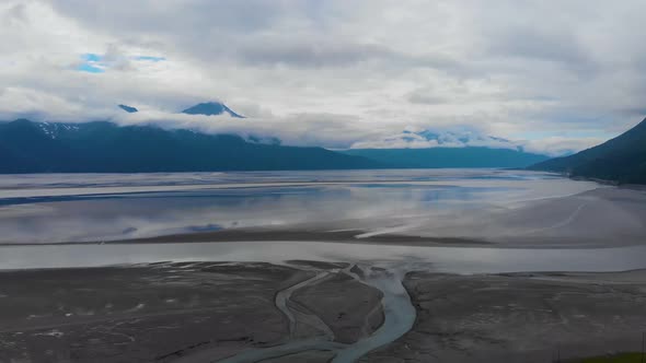 4K Cinematic Drone Video (slow dolly back) of Mountains Overlooking Turnagain Arm Bay at Low Tide Ne alt