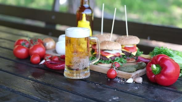 Cheeseburgers Served with French Fries on a Board Outdoors alt