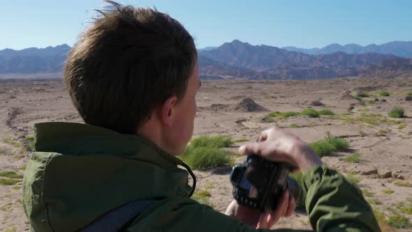 Photographer Takes Pictures of Mountain Landscape