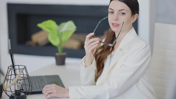 Seductive Slim Gorgeous Young Woman Taking Off Eyeglasses in Slow Motion Looking at Camera alt