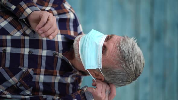 An Old Man Is Using Face Mask for Protect From Virus Against the Second Wave Quarantine Coronavirus