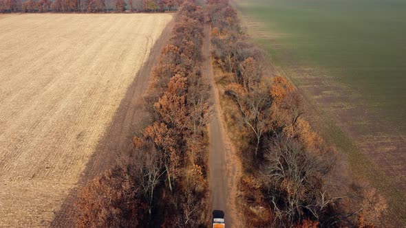 Aerial Drone View Flight Over Truck with an Empty Body Driving Along Dirt Road alt