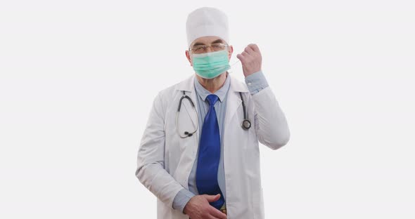 Doctor Takes Off the Face Mask. The End of Operation, Quarantine, Epidemic. Happy Smile. Isolated on alt
