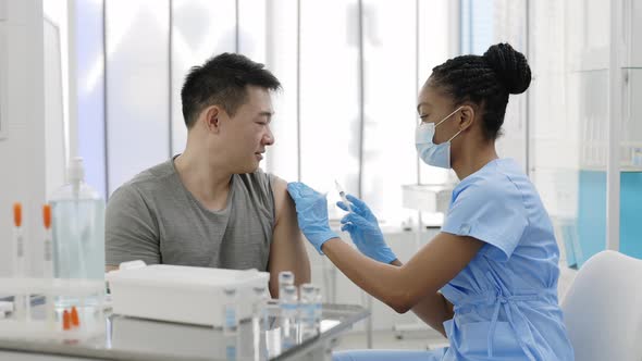 Asian Patient Getting a Shot at the Hospital or Clinic alt