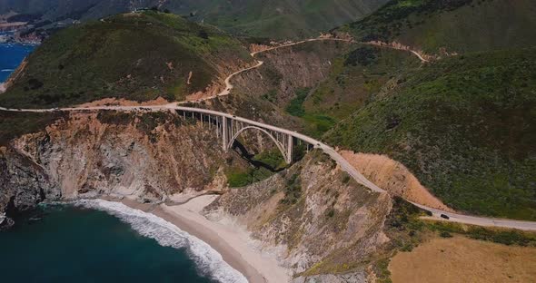 Beautiful Cinematic Aerial Shot of Epic Famous Bixby Canyon Bridge and Highway 1 Summer Scenery in alt