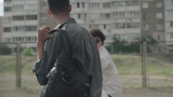 Side View of Laughing 1990s Men Having Fun As Walking Outdoors in City. Portrait of Positive alt