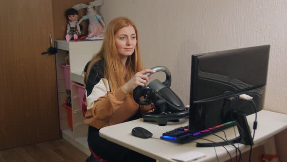 Woman Playing Racing On Wheel alt