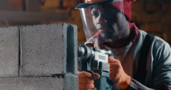 African American Builder Drilling Brick Wall alt