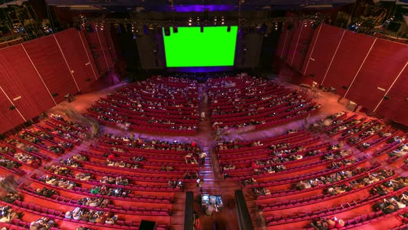 Cinema Movie Theater Auditorium with Viewers Red Chairs and Green Projection Screen Timelapse alt