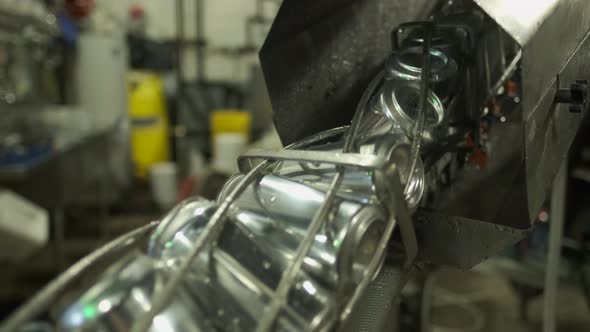 Beer Cans Inverted And Rinsed On A Microbrewery Canning Line alt