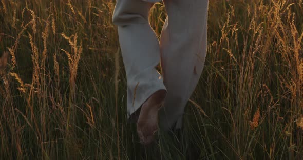 A Young Guy Walks Through a Wheat Field alt