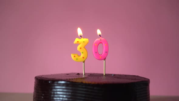 Chocolate Birthday Cake with Wick Lighting Trying to Blowout Candle alt